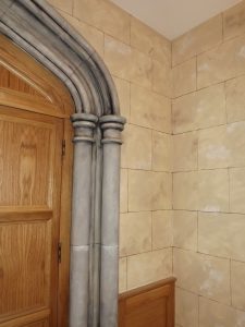Faux stone work and faux stone columns in this room made to look like a castle