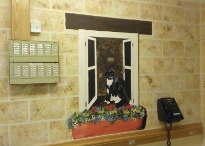 Trompe l'oeil window with cat and window box