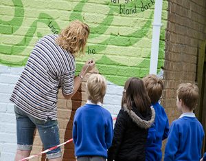 school children on a mural workshop