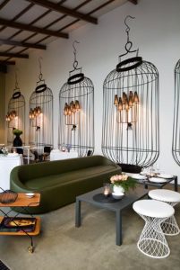 Repeated bird cage image on restaurant wall