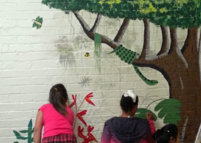 Image of children painting youth group mural