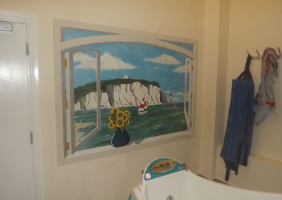 painted window mural with coastal view