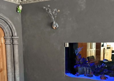 Grey travertino wall and faux stone columns