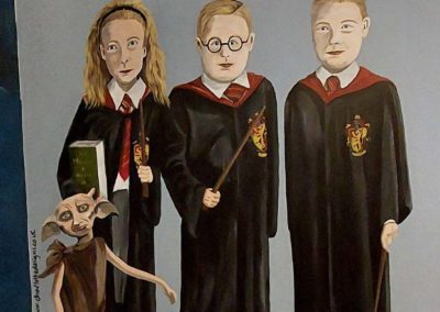 mural of 3 children dressed in gryffindor robes with dobby