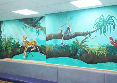 Jungle wall mural in hospital reception with Jaguar sloth