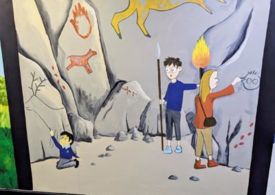 Stone Age boy book mural for wchool library