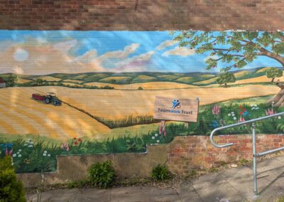 countryside mural with tractor, apple tree and flowers for Teamwork Trust charity