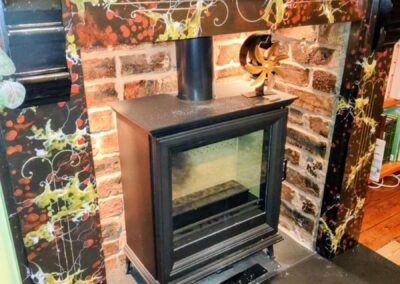 Richly detailed faux marble fireplace in reds, black and gold